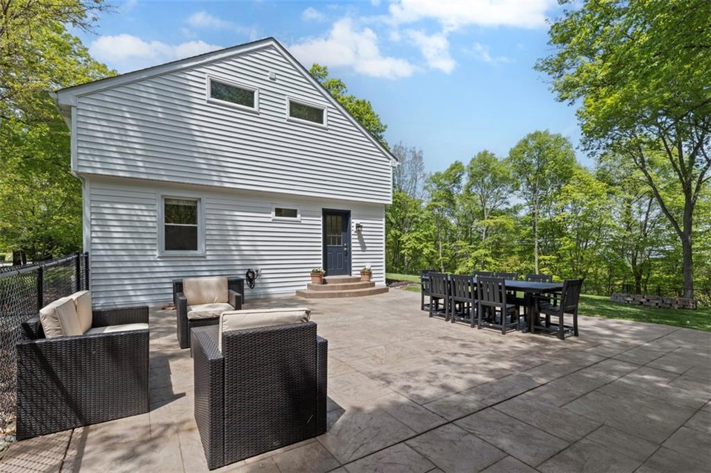 3566 Green Garden Road Aliquippa, PA 15001 - Photo 19 of 50 a view of a patio with a dining table and chairs with an umbrella