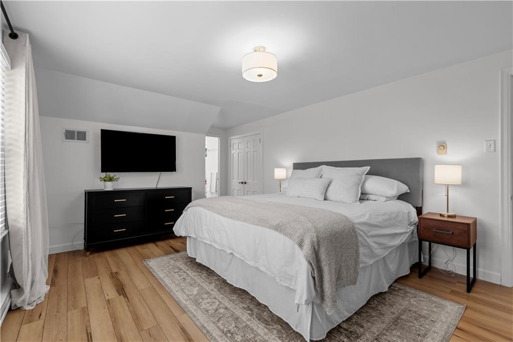 3566 Green Garden Road Aliquippa, PA 15001 - Photo 26 of 50 a bedroom with a bed and a flat tv screen on dresser