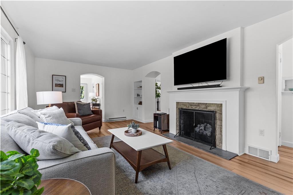 3566 Green Garden Road Aliquippa, PA 15001 - Photo 8 of 50 a living room with furniture a flat screen tv and a fireplace