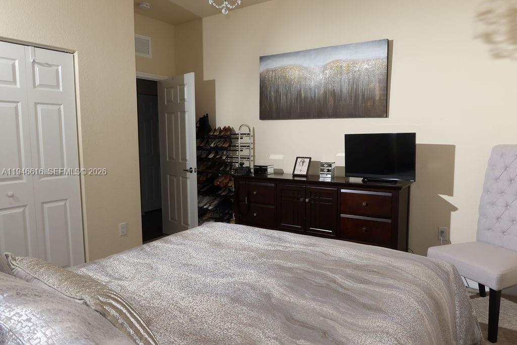 11601 Southwest 232nd Lane Homestead, FL 33032 - Photo 15 of 32 a bedroom with a bed and a flat screen tv