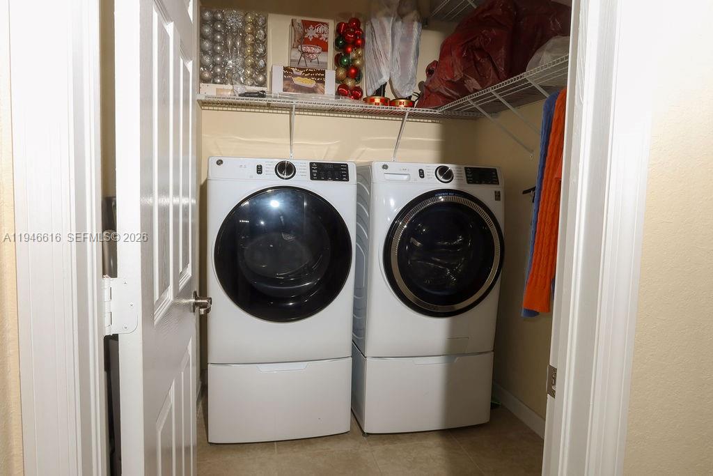 11601 Southwest 232nd Lane Homestead, FL 33032 - Photo 19 of 32 a utility room with dryer washer and a view of kitchen
