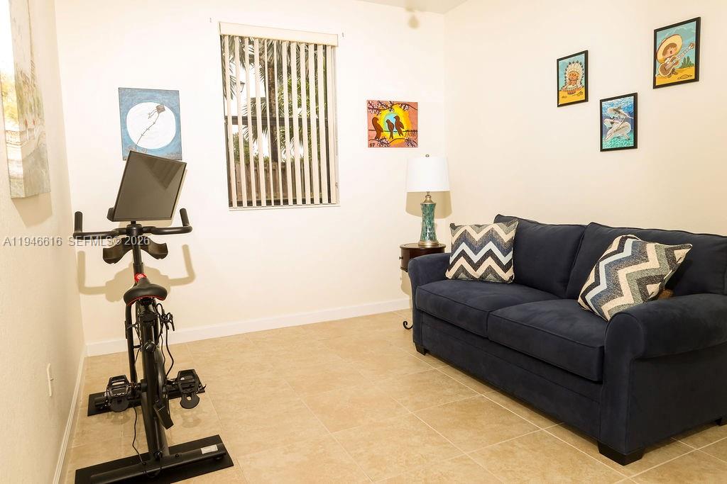 11601 Southwest 232nd Lane Homestead, FL 33032 - Photo 20 of 32 a living room with furniture and a flat screen tv