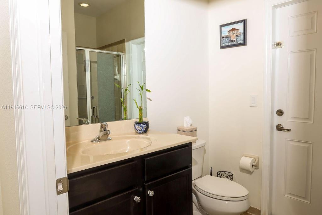 11601 Southwest 232nd Lane Homestead, FL 33032 - Photo 21 of 32 a bathroom with a sink a toilet and shower