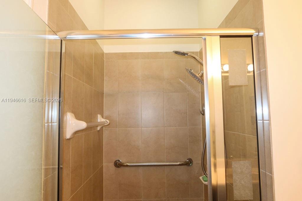 11601 Southwest 232nd Lane Homestead, FL 33032 - Photo 22 of 32 a bathroom with a glass shower door