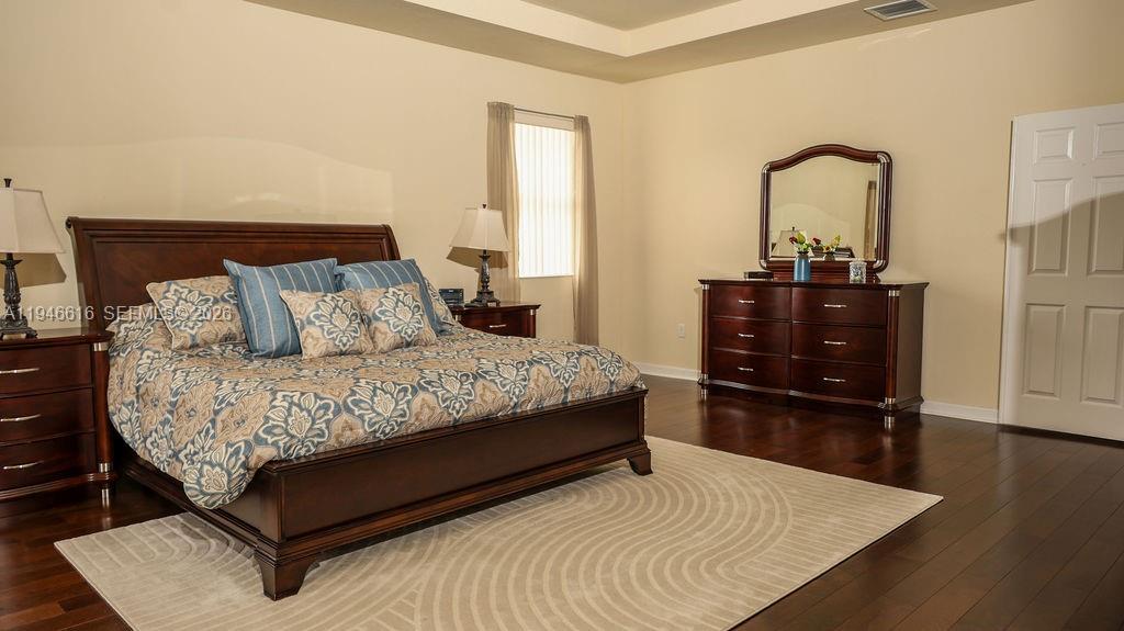 11601 Southwest 232nd Lane Homestead, FL 33032 - Photo 3 of 32 a bedroom with a bed and a dresser