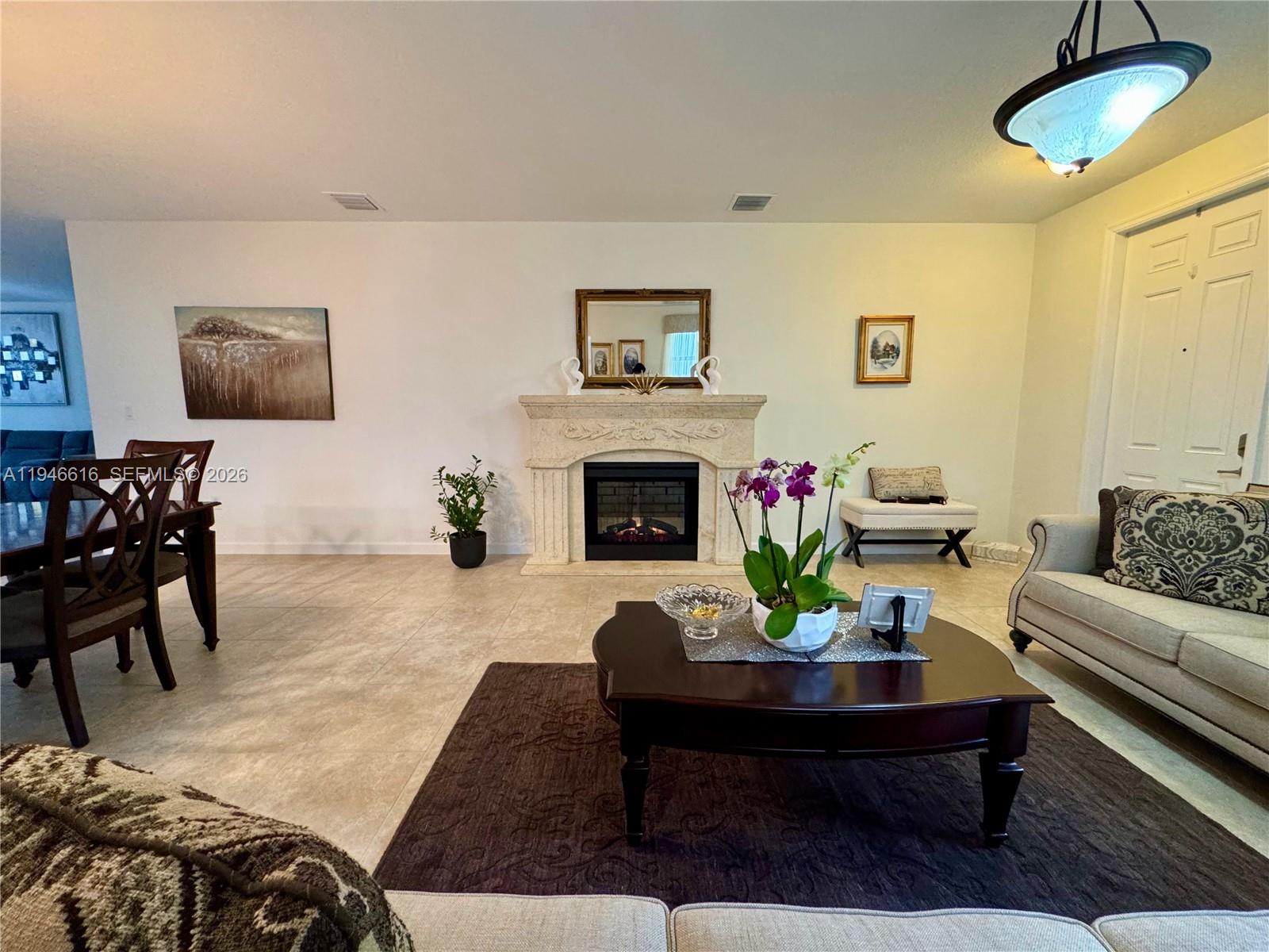 11601 Southwest 232nd Lane Homestead, FL 33032 - Photo 5 of 32 a living room with furniture and a fireplace