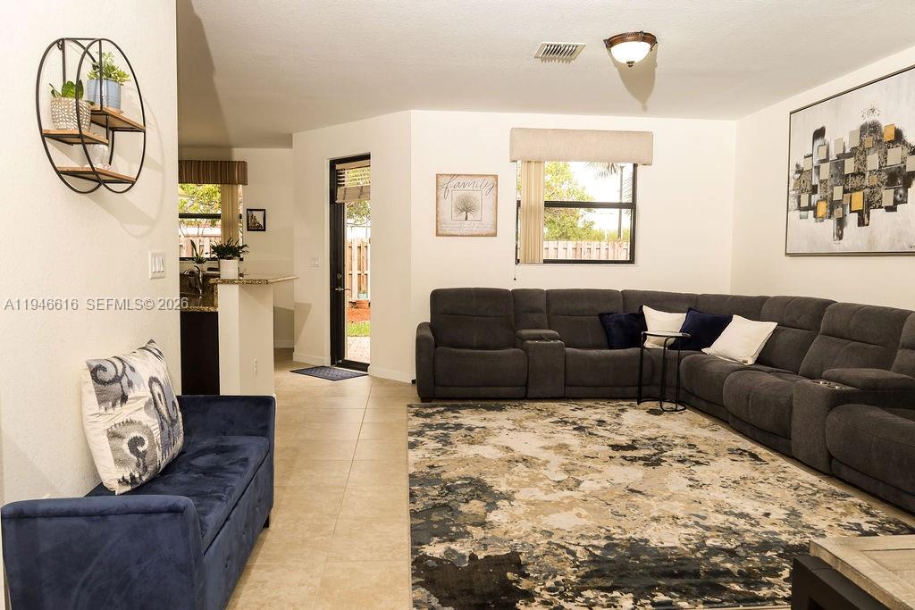 11601 Southwest 232nd Lane Homestead, FL 33032 - Photo 9 of 32 a living room with furniture a couch and a window