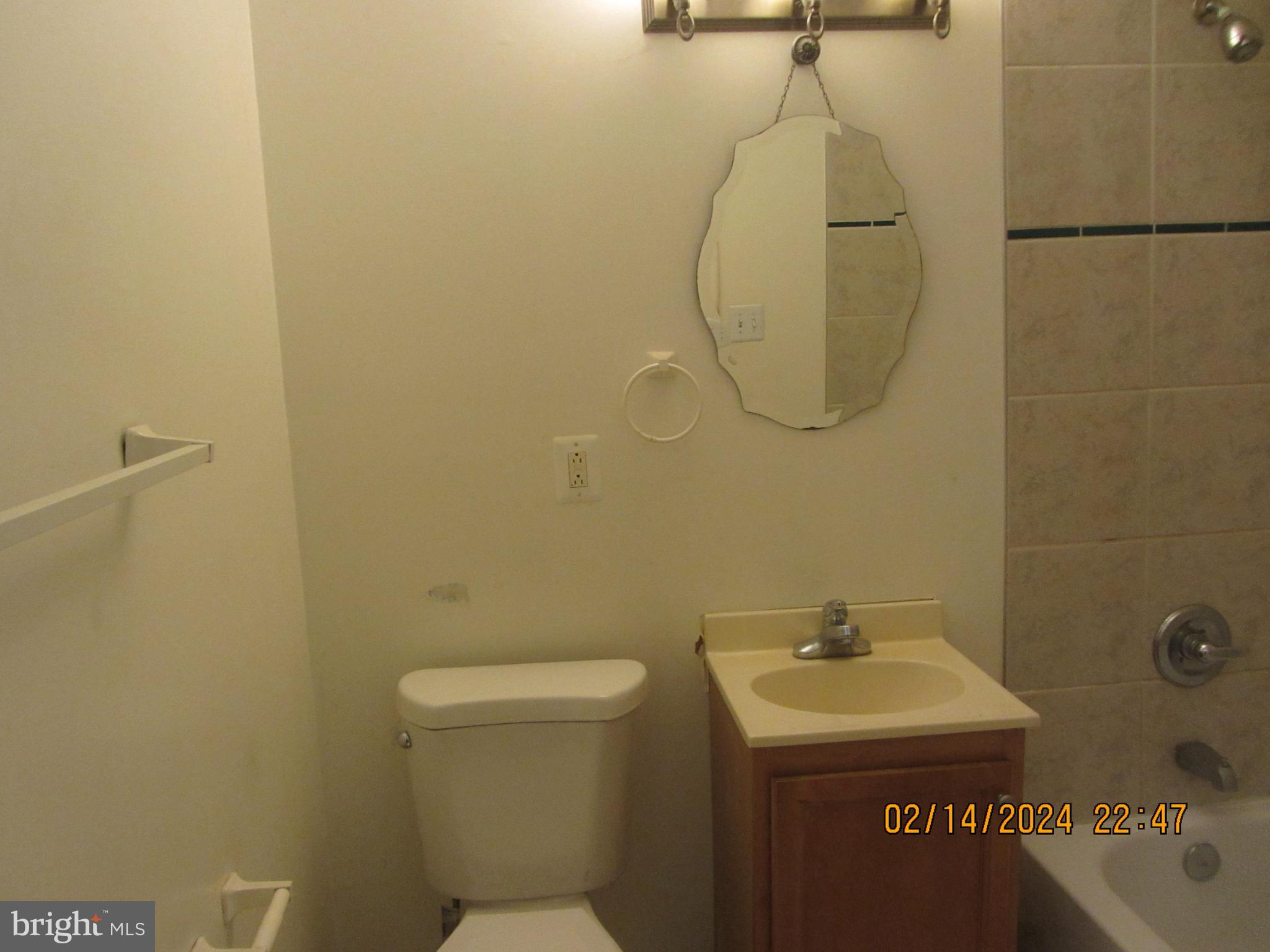 7801 Greenleaf Road Hyattsville, MD 20785 - Photo 30 of 51 a bathroom with a sink a toilet and a mirror