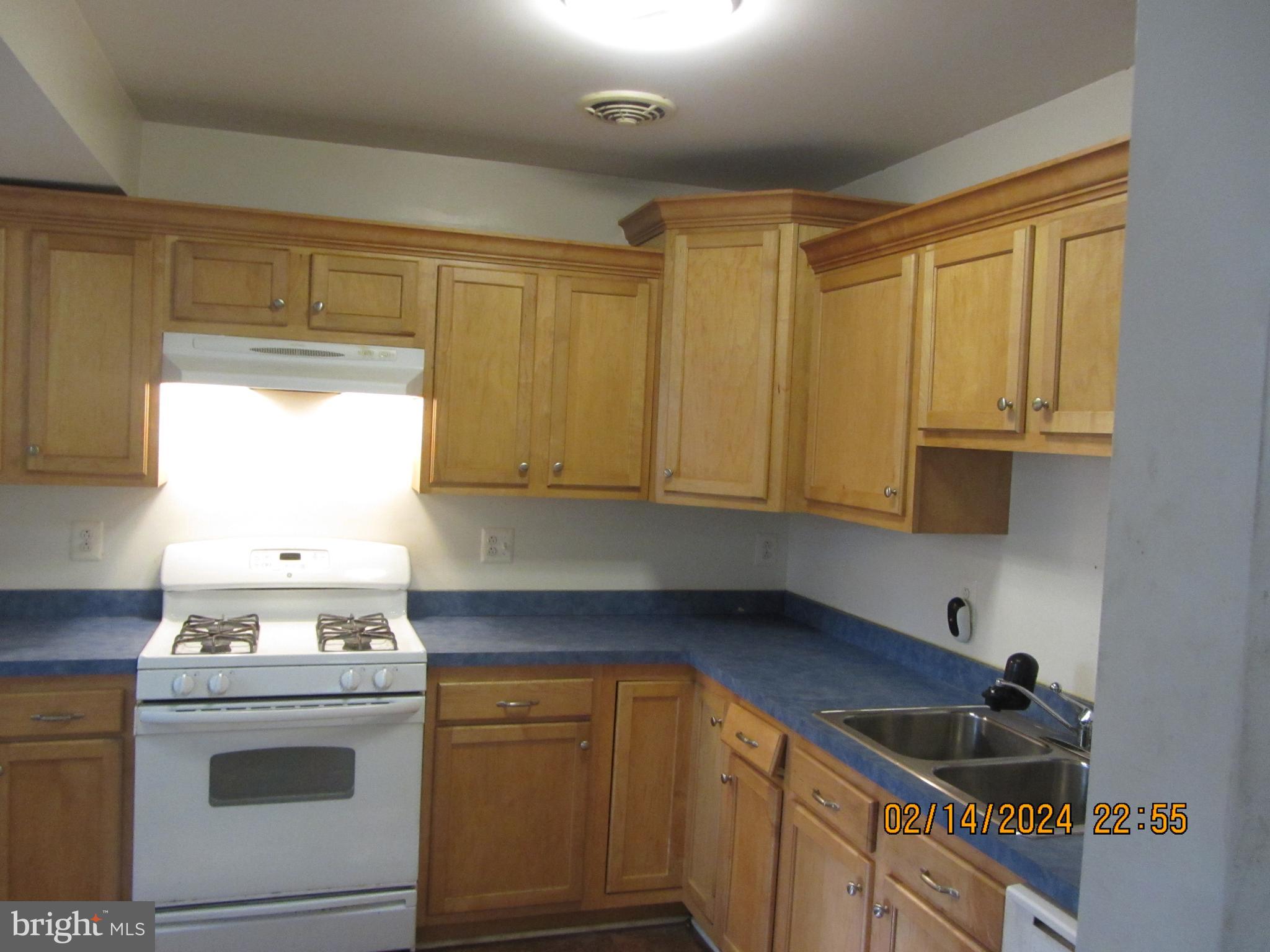 7801 Greenleaf Road Hyattsville, MD 20785 - Photo 4 of 51 a kitchen with a sink stove top oven and cabinets