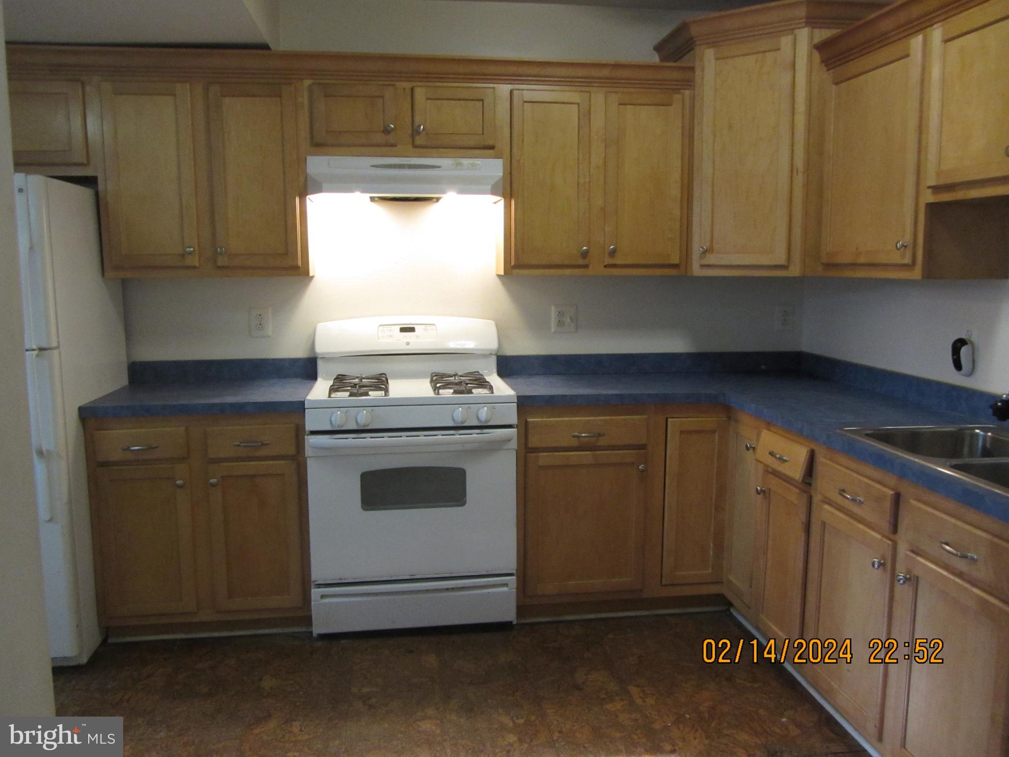 7801 Greenleaf Road Hyattsville, MD 20785 - Photo 6 of 51 a kitchen with granite countertop white cabinets and white appliances