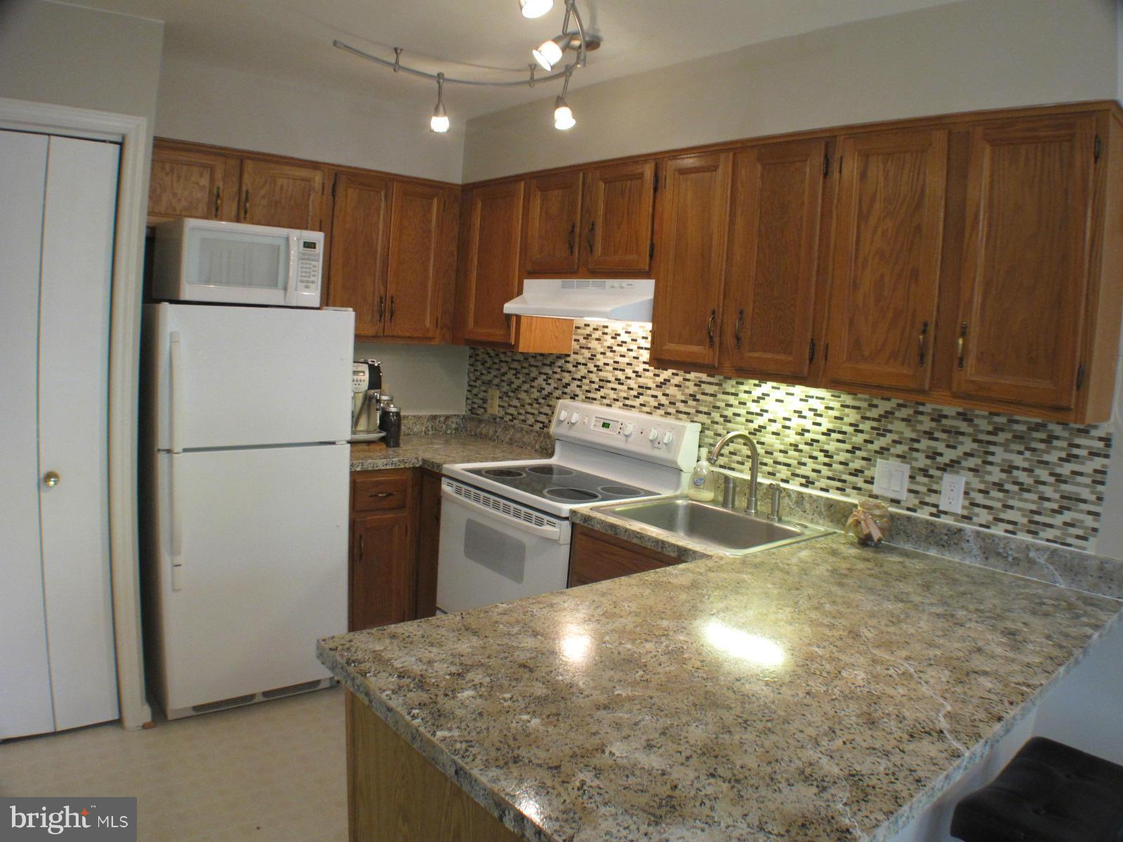 6002 Rabbit Hill Court Centreville, VA 20121 - Photo 13 of 29 a kitchen with granite countertop stainless steel appliances and wooden cabinets