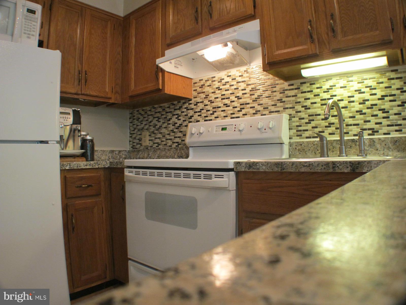 6002 Rabbit Hill Court Centreville, VA 20121 - Photo 15 of 29 a kitchen with granite countertop a stove and a sink