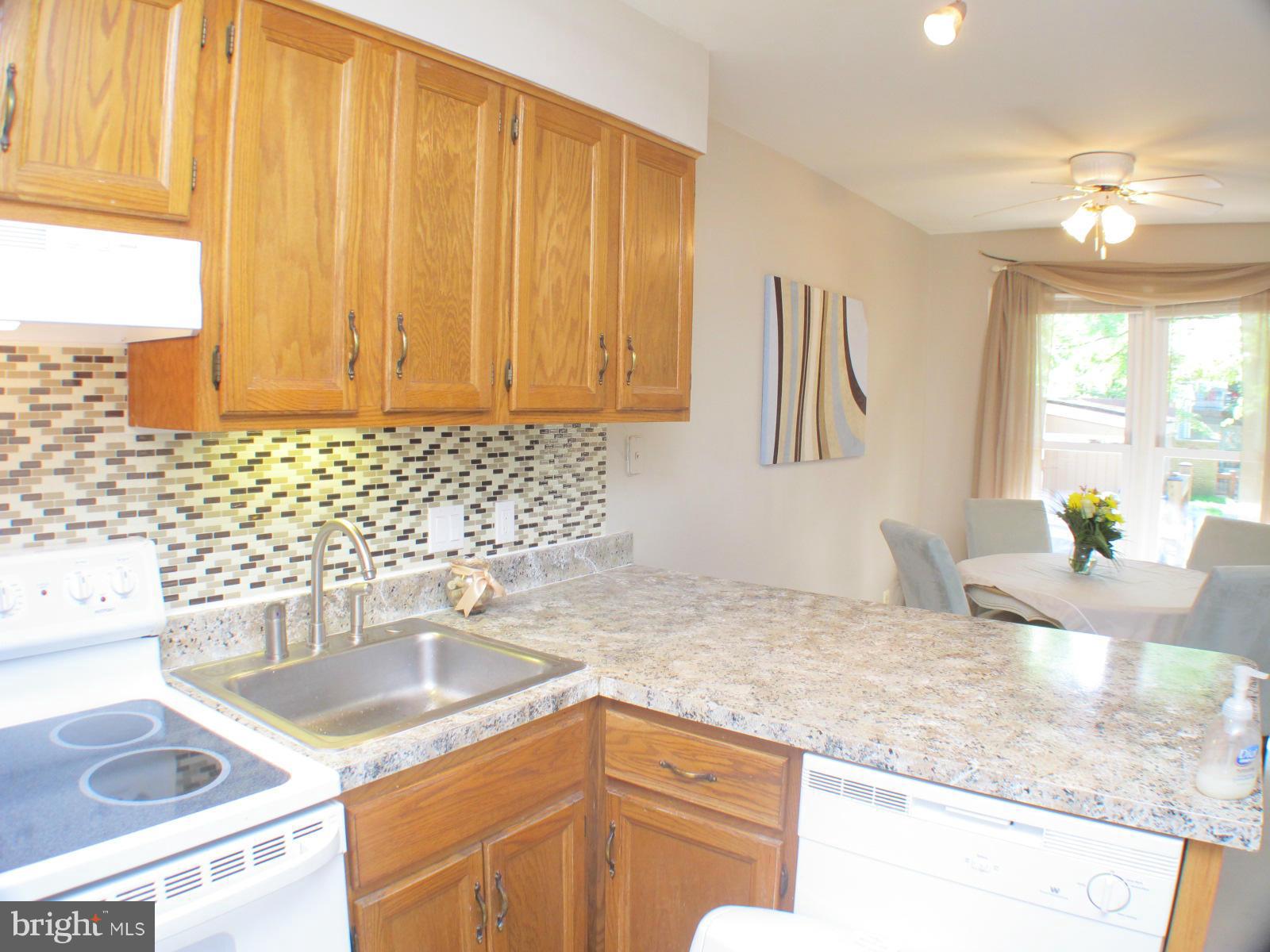 6002 Rabbit Hill Court Centreville, VA 20121 - Photo 16 of 29 a kitchen with a sink stove and cabinets