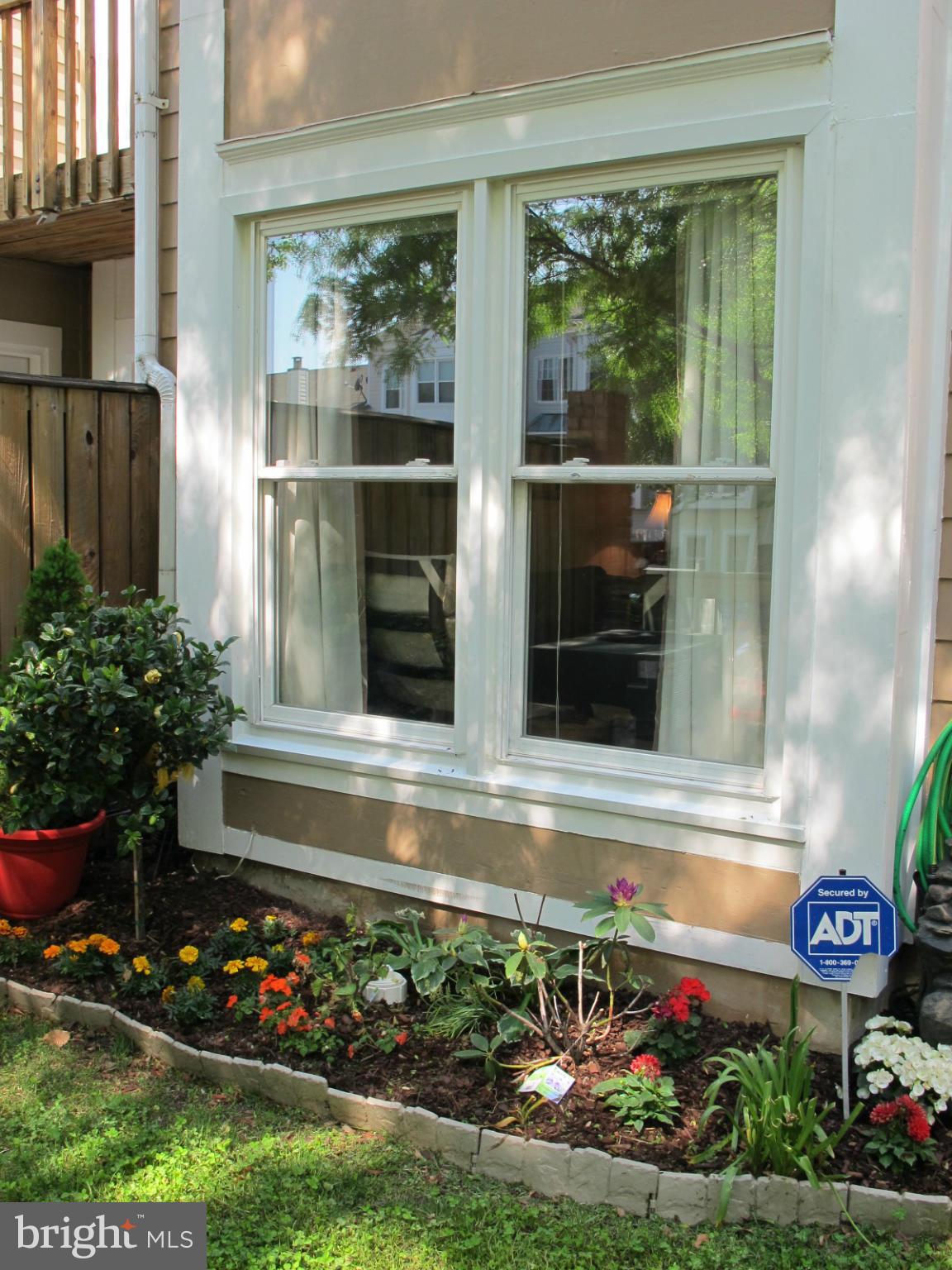 6002 Rabbit Hill Court Centreville, VA 20121 - Photo 27 of 29 a view of a house with a large window and flower plants