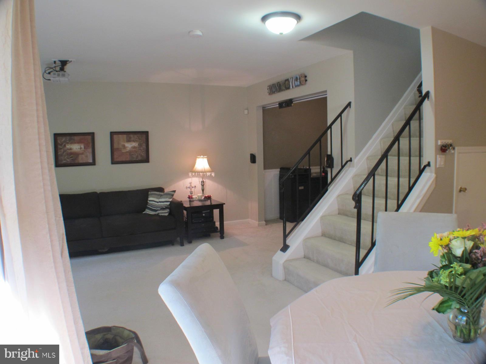 6002 Rabbit Hill Court Centreville, VA 20121 - Photo 4 of 29 a living room with furniture potted plants and a lamp