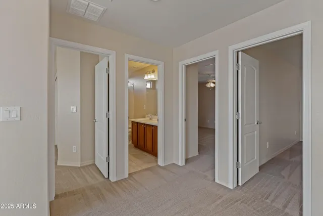 a view of a bathroom with a glass door and a sink