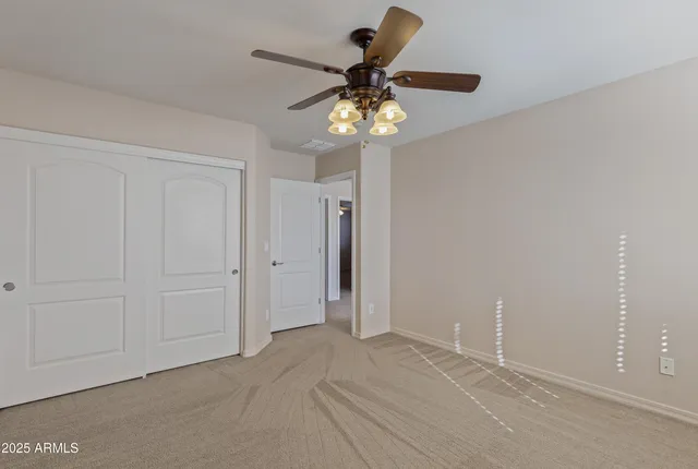 a bathroom with a granite countertop sink a toilet a mirror and shower