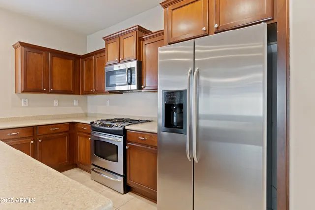 a kitchen with cabinets and stainless steel appliances