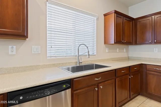 a kitchen with granite countertop a sink and cabinets