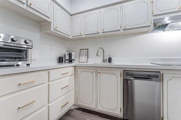 a kitchen with white cabinets and a sink