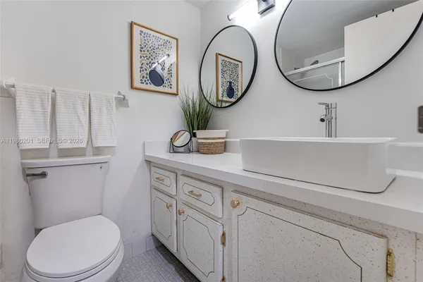 a bathroom with a toilet a sink and a mirror