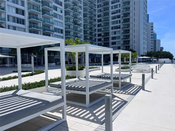 a view of a patio with table and chairs and potted plants