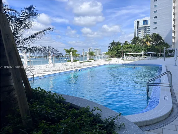 a view of a swimming pool with a yard