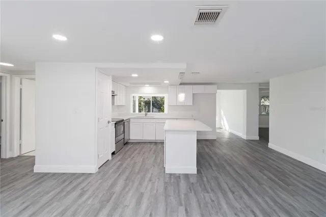 a kitchen with a white table and chairs