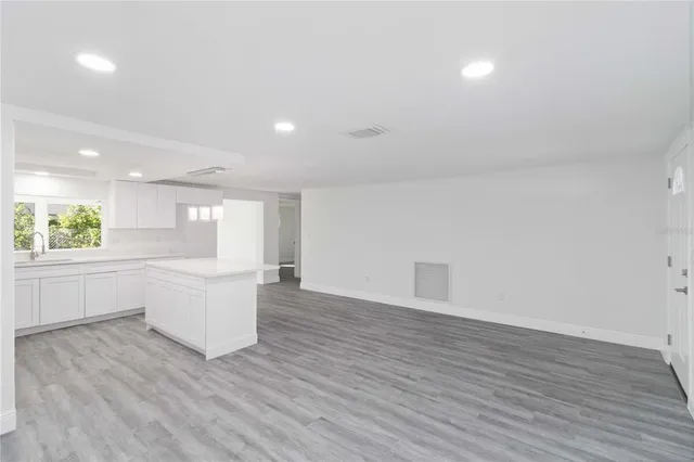 a view of kitchen with wooden floor and electronic appliances