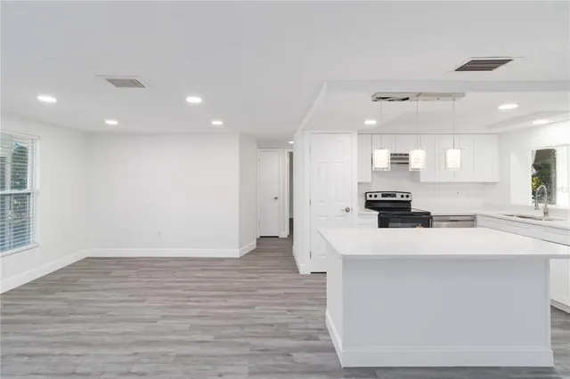 a kitchen with stainless steel appliances a refrigerator sink and wooden cabinets