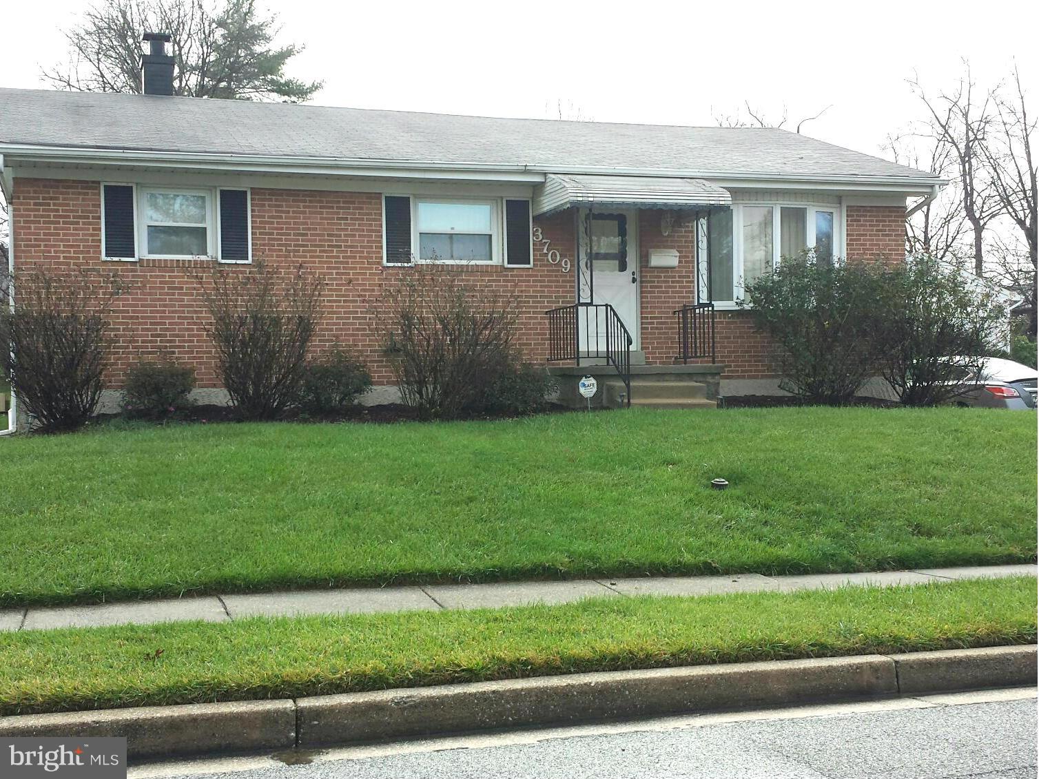 3709 Parkfield Road Baltimore, MD 21244 - Photo 2 of 23 a front view of a house with a yard and garage