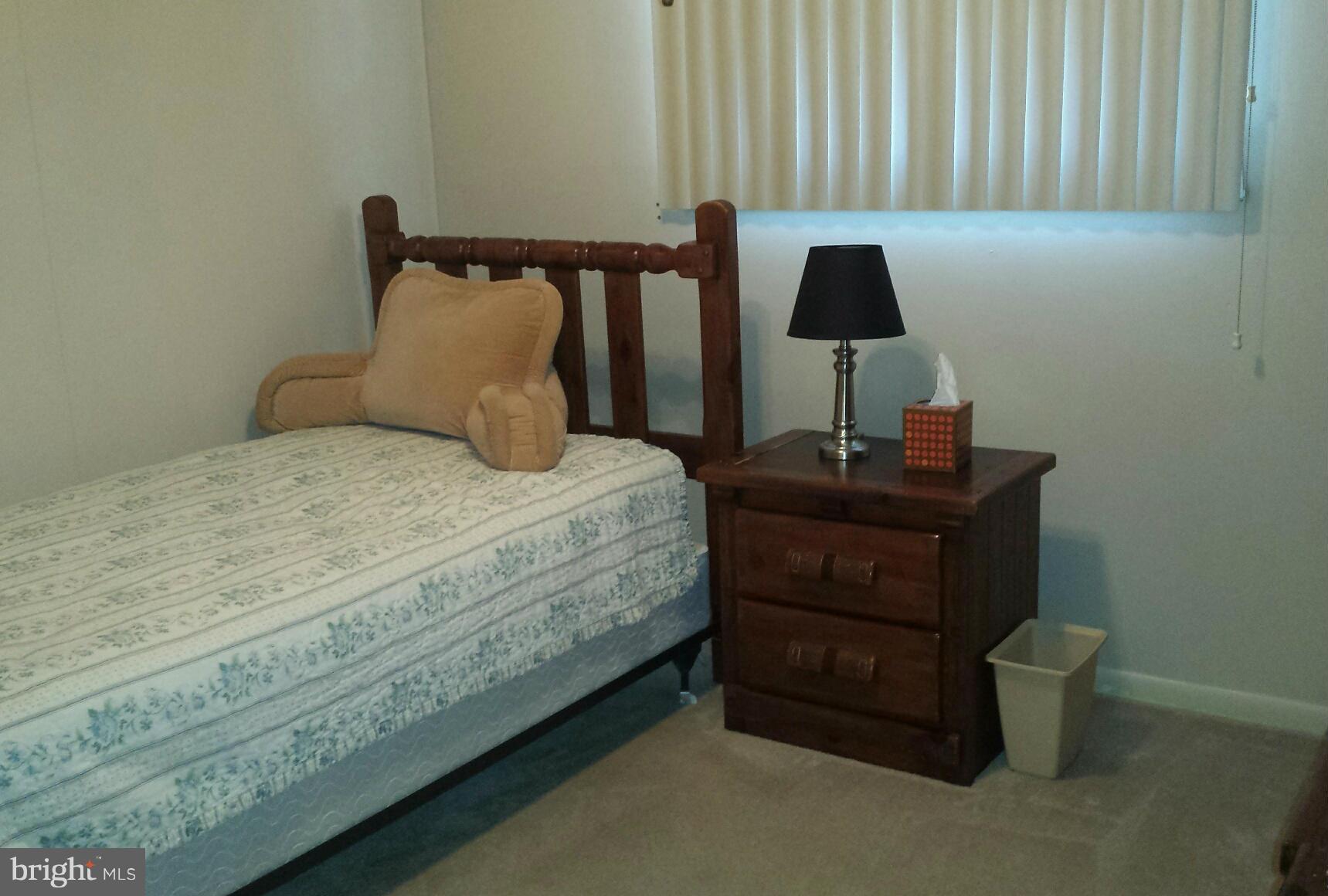 3709 Parkfield Road Baltimore, MD 21244 - Photo 13 of 23 a bedroom with a bed and a lamp on the dresser
