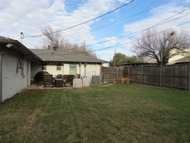a view of a backyard with sitting area and slide