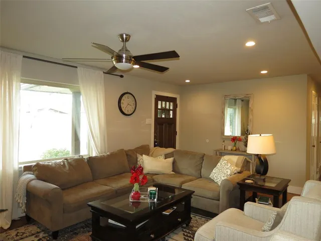 a living room with furniture a chandelier and a window