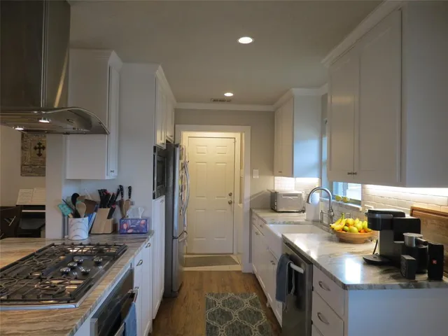 a kitchen with a stove and a refrigerator