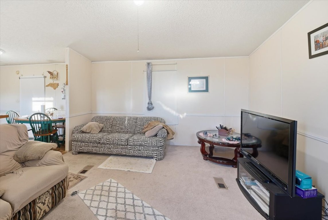 675 Highland Ranch Way Dale, TX 78616 - Photo 12 of 21 a living room with furniture and a flat screen tv