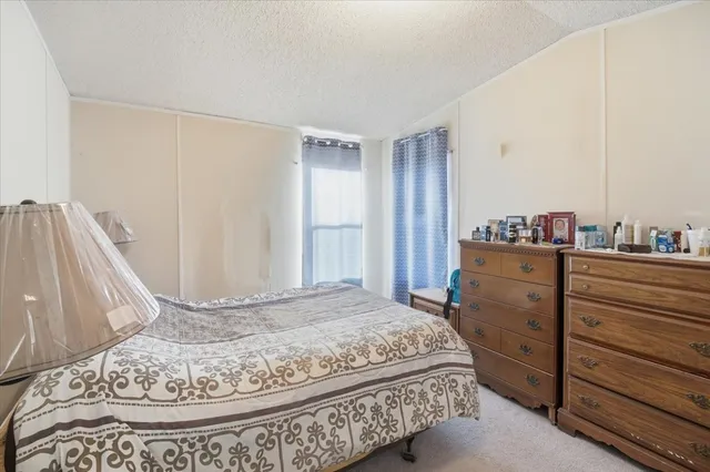 a bedroom with furniture and a window
