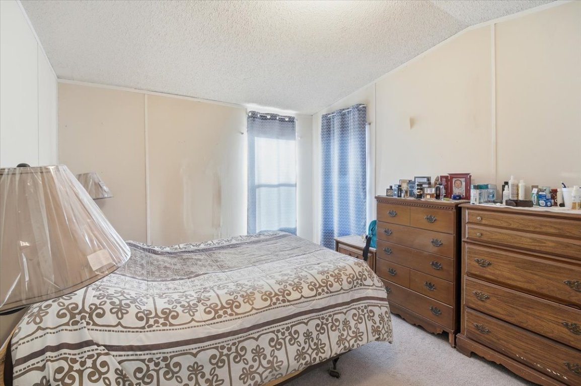 675 Highland Ranch Way Dale, TX 78616 - Photo 16 of 21 a bedroom with a bed and a dresser