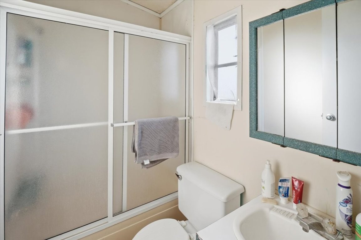 675 Highland Ranch Way Dale, TX 78616 - Photo 19 of 21 a bathroom with a toilet and a shower