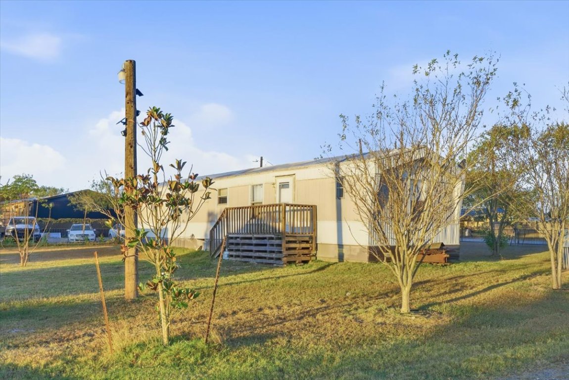 675 Highland Ranch Way Dale, TX 78616 - Photo 2 of 21 a roof deck with table and chairs and potted plants