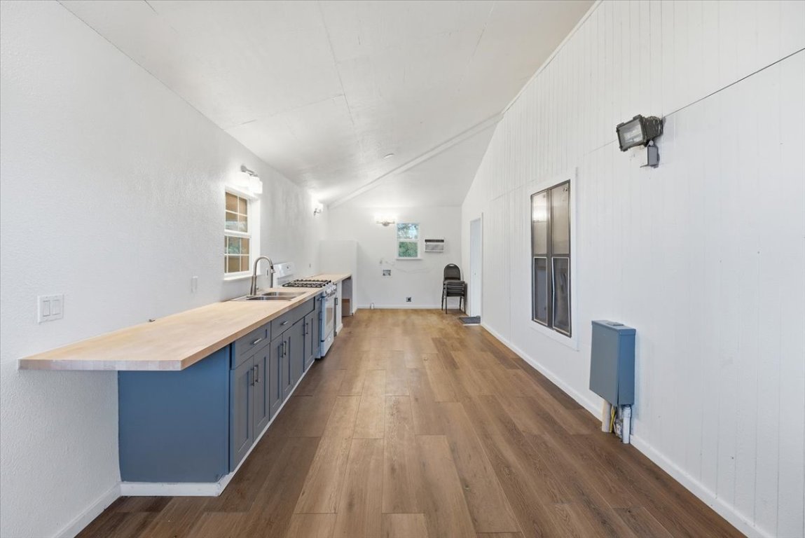 675 Highland Ranch Way Dale, TX 78616 - Photo 21 of 21 a large kitchen with a wooden floor and large windows