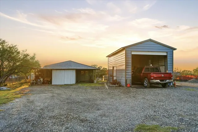 a view of a house with a yard and garage