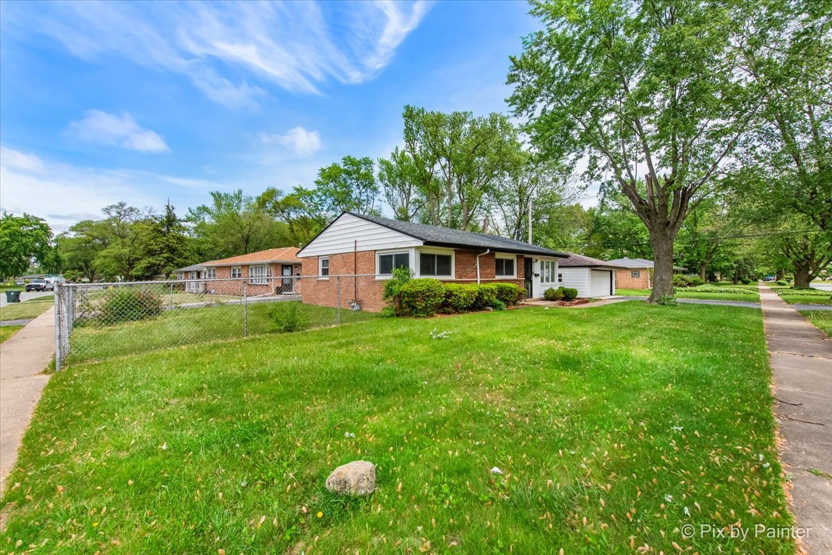 2756 Lancaster Drive Markham, IL 60428 - Photo 6 of 6 a front view of house with yard and green space
