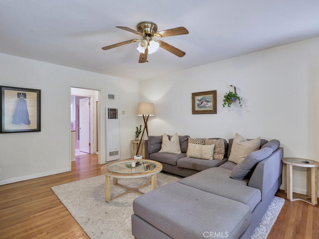 3042 East 3rd Street, Unit 5 Long Beach, CA 90814 - Photo 11 of 25 a living room with furniture and a wooden floor