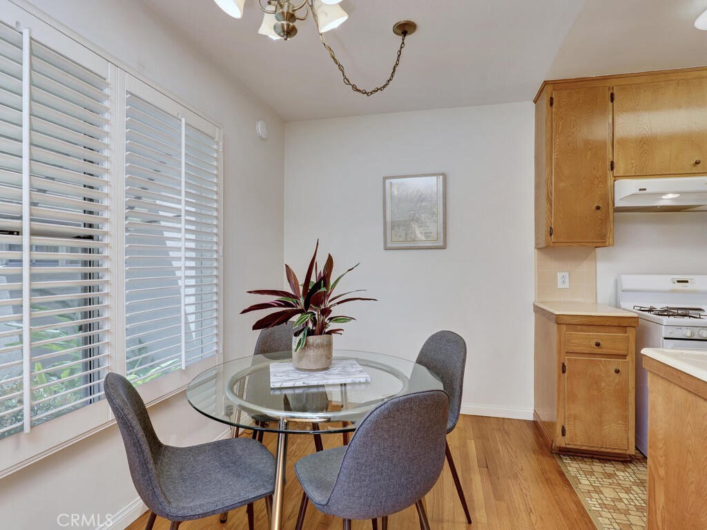 3042 East 3rd Street, Unit 5 Long Beach, CA 90814 - Photo 13 of 25 a view of a dining room with furniture and wooden floor