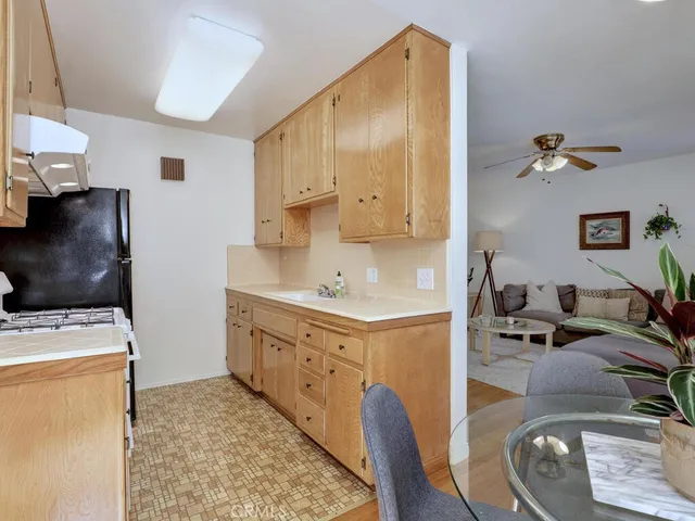 a kitchen with stainless steel appliances granite countertop a sink a stove and a refrigerator