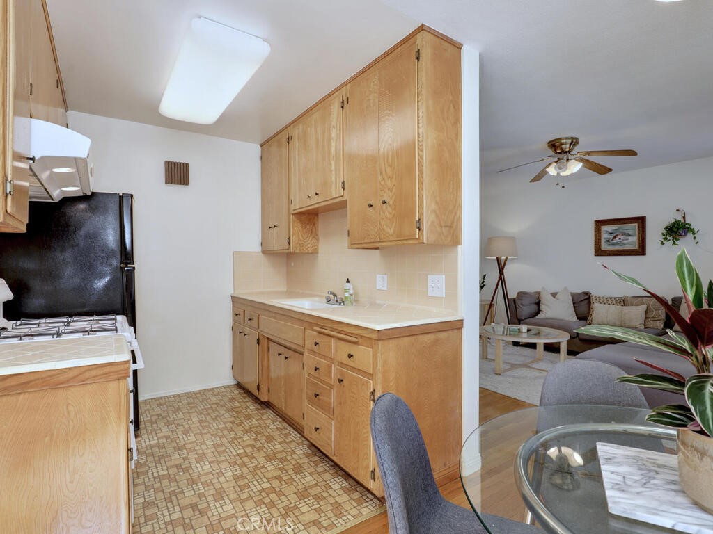 3042 East 3rd Street, Unit 5 Long Beach, CA 90814 - Photo 14 of 25 a kitchen with stainless steel appliances granite countertop a sink a stove and a refrigerator
