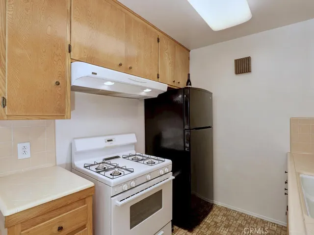 a kitchen with a stove and a refrigerator