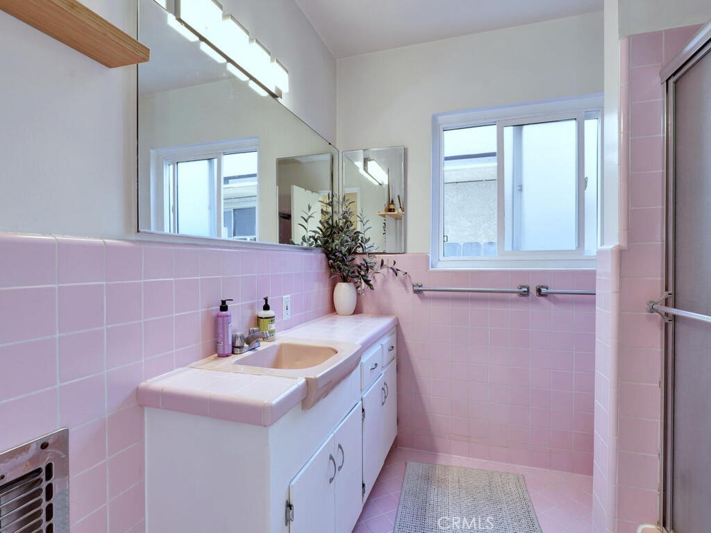 3042 East 3rd Street, Unit 5 Long Beach, CA 90814 - Photo 17 of 25 a bathroom with a sink a vanity and a mirror