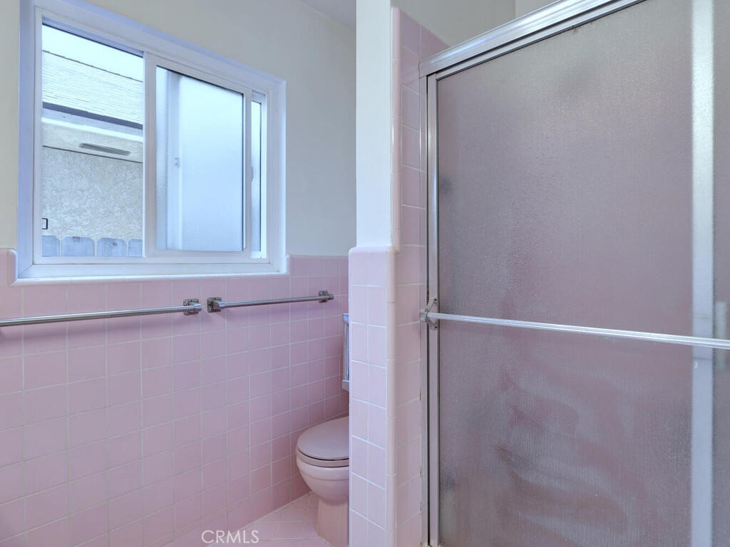 3042 East 3rd Street, Unit 5 Long Beach, CA 90814 - Photo 18 of 25 a bathroom with a granite countertop shower and a toilet